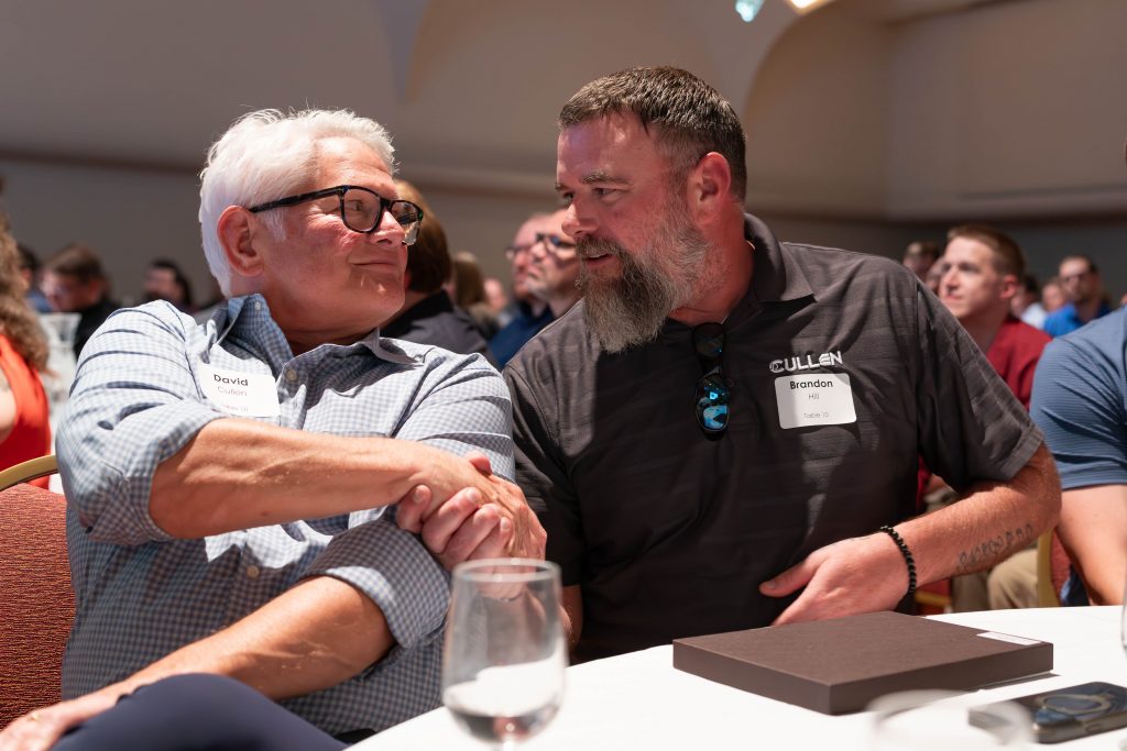 Award winner Brandon Hill shaking David Cullen's hand